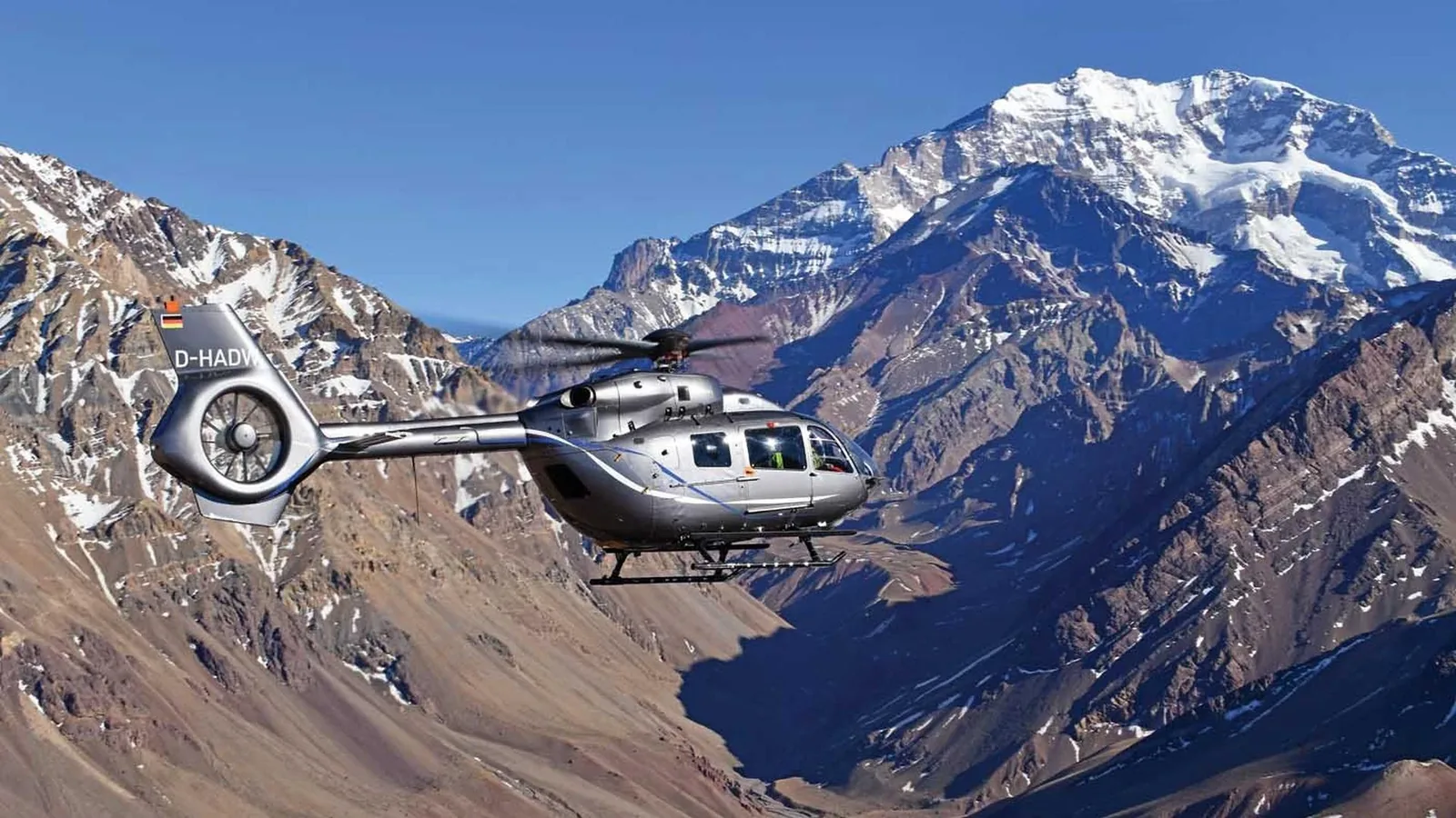 Helicopter flying above a mountain landscape